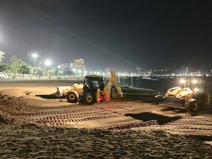 Crews work through the night to repair flood damage on Pattaya Beach.