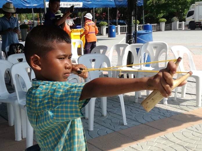 A young sharpshooter takes aim in the slingshot competition.