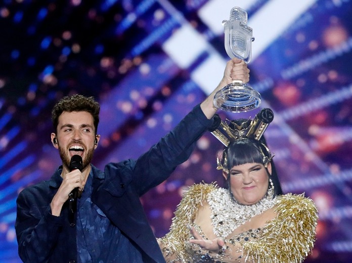 Duncan Laurence of the Netherlands (left) celebrates with the trophy after winning the 2019 Eurovision Song Contest grand final with the song "Arcade" in Tel Aviv, Israel, Saturday, May 18. Standing right is Israeli Netta Barzilai, the winner in 2018. (AP Photo/Sebastian Scheiner)