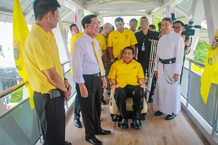 Mayor Sonthaya Kunplome, who due to a recent lower limb accident was sitting in a wheelchair, gets a firsthand look at the convenience the bridge affords people with disabilities.