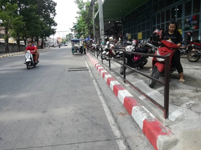 City workers have painted no-parking markers on curbs behind Central Marina shopping mall.