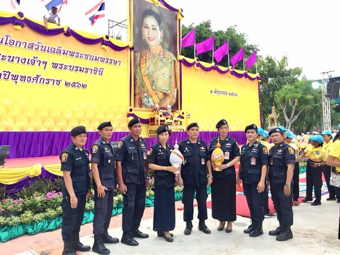 Police volunteers pay their respects to HM the Queen Suthida.