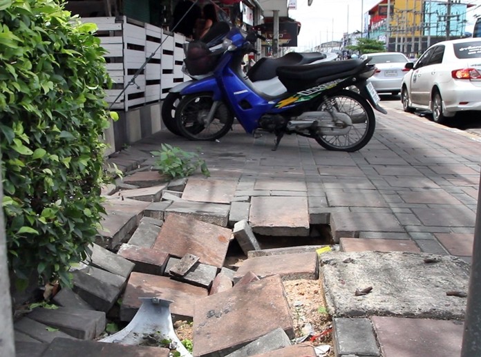 Footpaths on both sides of the street near the CAT Telecom building are cracked, broken and uneven due to repeated flooding.