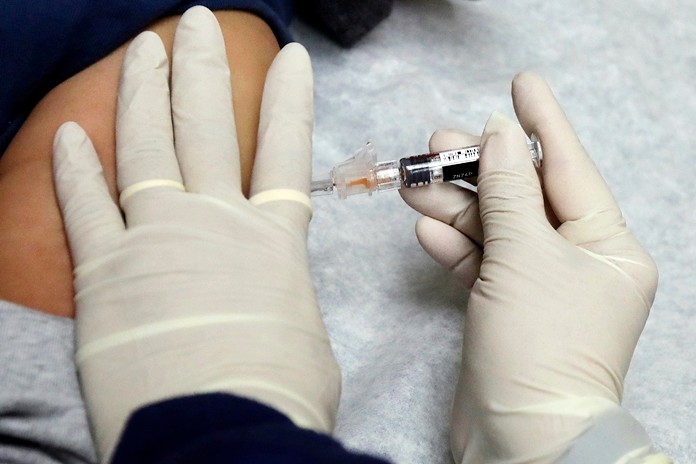 In this Jan. 12, 2018, file photo, a medical assistant at a community health center gives a patient a flu shot in Seattle. U.S. health officials say the flu vaccine has again turned out to be a disappointment. (AP Photo/Ted S. Warren, File)