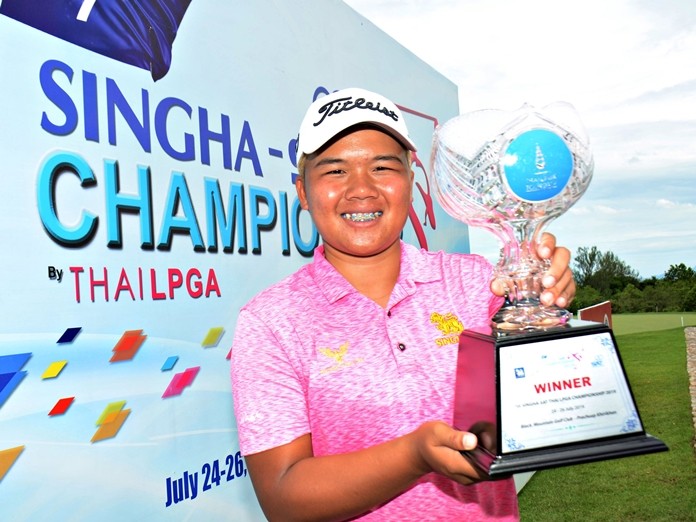 Kusuma Meechai poses with the trophy after winning the Singha Thai LPGA Tour event at Black Mountain Golf Club in Hua Hin on July 26, 2019.