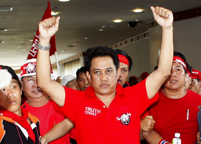 In this April 11, 2009, file photo, anti-government leader Arisman Pongruangrong is cheered as he and others march through the 14th ASEAN Convention Center at the Peach Conference Center, Royal Cliff Hotel in Pattaya. (AP Photo/David Longstreath)