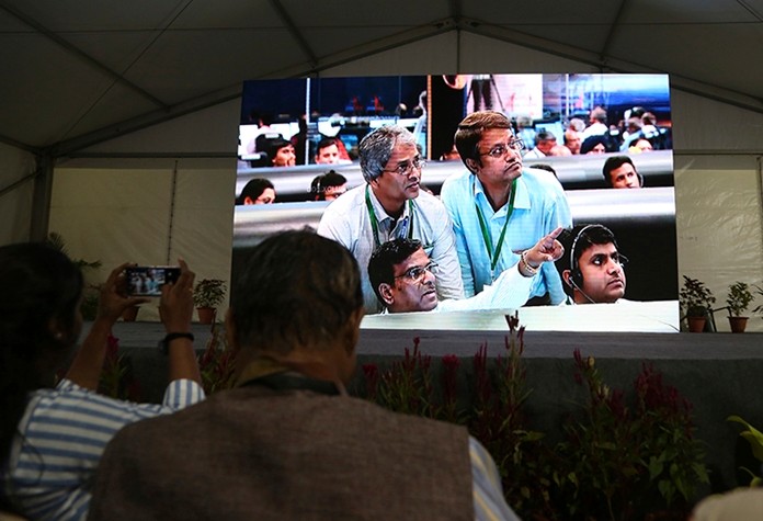 Live pictures of Indian Space Research Organization (ISRO) scientists reacting are displayed on a big screen at their Telemetry, Tracking and Command Network. (AP Photo/Aijaz Rahi)