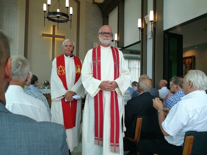 Pastors Ragnvald Seierstad and Ørnulf Steen perform the consecration ceremonies. (Photo courtesy of ScandAsia)