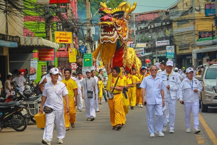 Sawang Boriboon Thammasathan Foundation President Wisit Chaowalitnittithum leads the dragon and lion parade through Naklua streets during last year’s event.