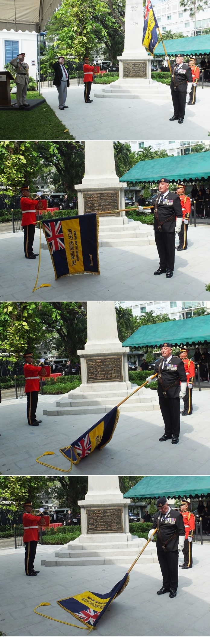 Defence Attaché Colonel Roger Lewis and Middy Campbell salute as Standard bearer Richard Holmes lowers the Royal British Legion standard to the sound of the Buglers.