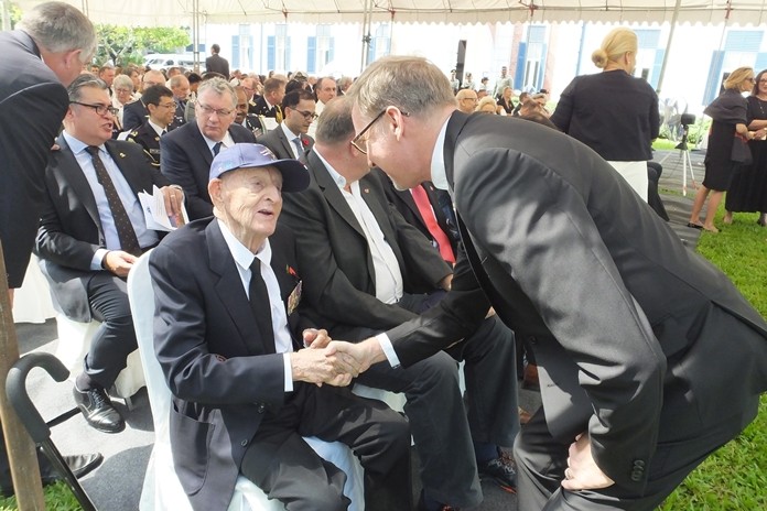 The British Ambassador greets Archie Dunlop.