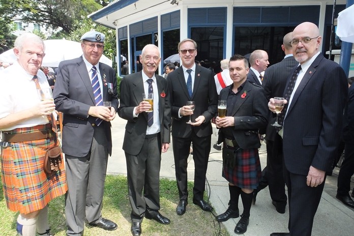 H.E. Brian Davidson enjoying a drink with attendees.