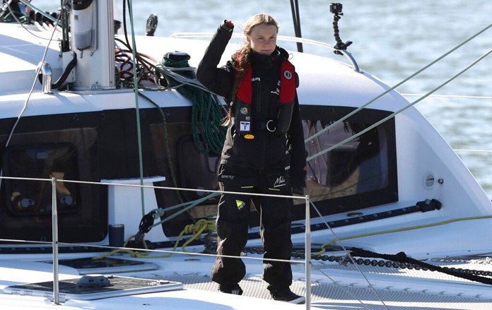 Climate activist Greta Thunberg waves as she arrives in Lisbon aboard the sailboat La Vagabonde Tuesday, Dec 3, 2019. (AP Photo/Pedro Rocha)