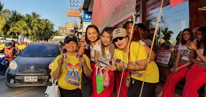 Volunteers hand out free condoms along the parade route.