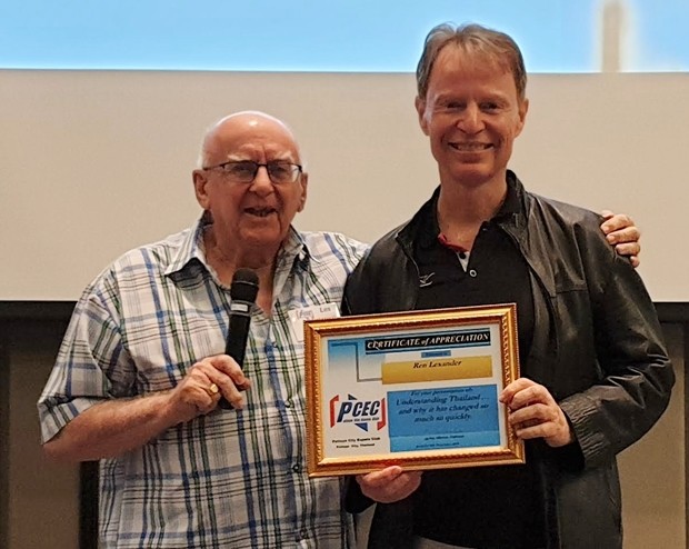 MC Les Edmonds presents Dr. Ren Lexander with the PCEC's Certificate of Appreciation for his insightful and interesting talk about the difference between the beliefs of Thais and Westerners as well as explaining why Thailand has recently changed so much so rapidly.