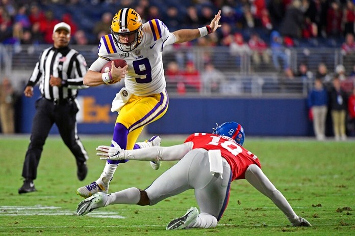 In this Nov. 16, 2019, file photo, LSU quarterback Joe Burrow (9) avoids Mississippi linebacker Jacquez Jones (10) during the first half of an NCAA college football game, in Oxford, Miss. LSU quarterback Joe Burrow is The Associated Press college football player of the year in a landslide vote.  (AP Photo/Thomas Graning, File)