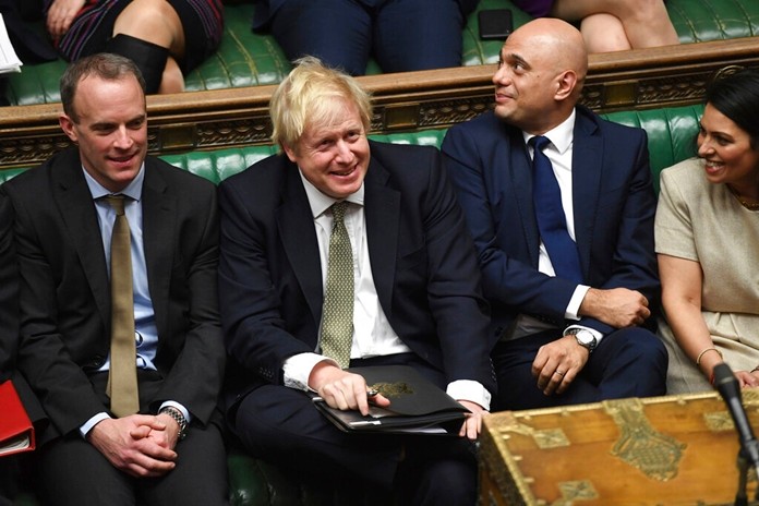 In this photo made available by the UK Parliament, Britain's Prime Minister Boris Johnson, center, attends the debate in the House of Commons, London, Thursday Dec. 19, 2019. (Jessica Taylor/UK Parliament via AP)