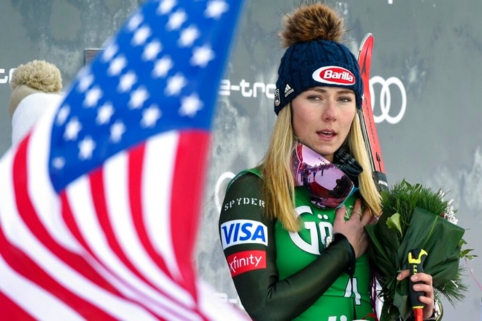 United States' Mikaela Shiffrin, winner of an alpine ski, women's World Cup giant slalom, listens to the national anthem, in Lienz, Austria, Saturday, Dec. 28, 2019. (AP Photo/Piermarco Tacca)