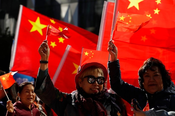 Pro-Beijing supporters wave the Chinese national flags during a rally in Hong Kong on Saturday, Dec. 7, 2019. (AP Photo/Mark Schiefelbein)