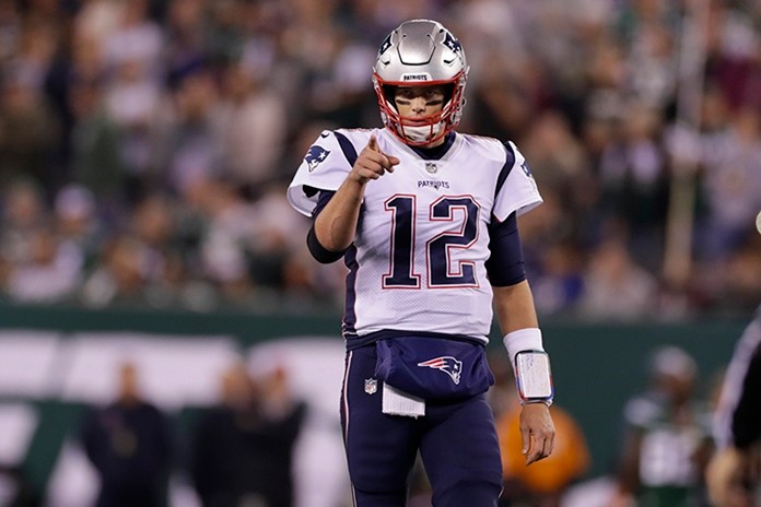 New England Patriots quarterback Tom Brady (12) points to Benjamin Watson (84) after a play during the first half of an NFL football game. (AP Photo/Adam Hunger)