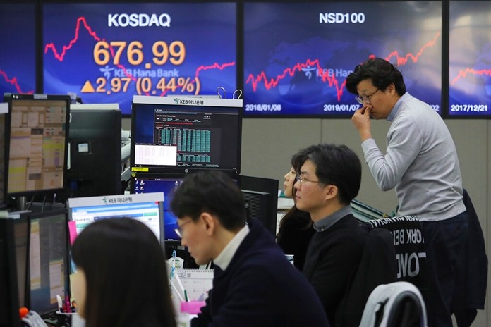 Currency traders watch monitors at the foreign exchange dealing room of the KEB Hana Bank headquarters in Seoul, South Korea, Friday, Jan. 3, 2020. (AP Photo/Ahn Young-joon)