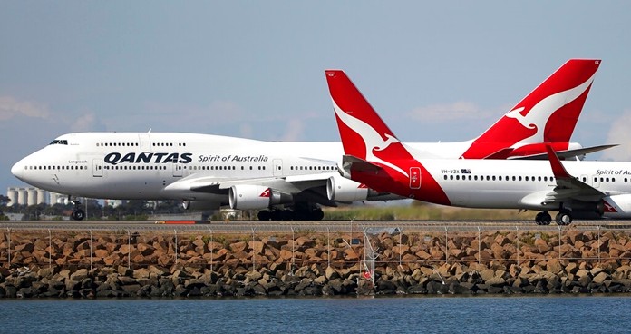 In this Aug. 20, 2015 file photo, two Qantas planes taxi on the runway at Sydney Airport in Sydney, Australia. (AP Photo/Rick Rycroft, File)