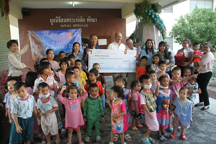 Centara Grand Mirage Beach Resort Area General Manager Denis Thouvard, Asst. GM Yaree Nealsen and resort staff hand over funds raised at the annual Christmas Tree Lighting in December.