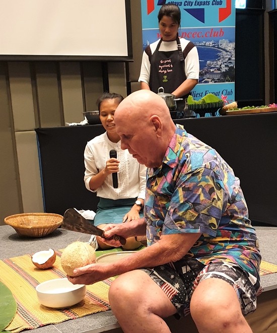 Is this how you do it? PCEC Member Ron Dittmer prepares to cut open a coconut according to Sasi's instructions. He succeeded without cutting off any fingers to the delight (disappointment?) of the audience.