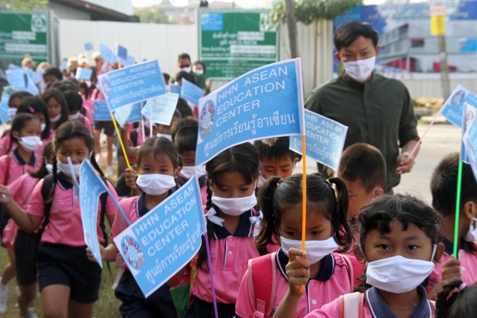 Children are marched over to the new facility while carrying their power blue identification flags to try and make sure no one gets lost.