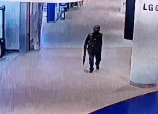 A CCTV grab shows the gunman holding his heavy weapon as he walks through Terminal 21 in Korat.