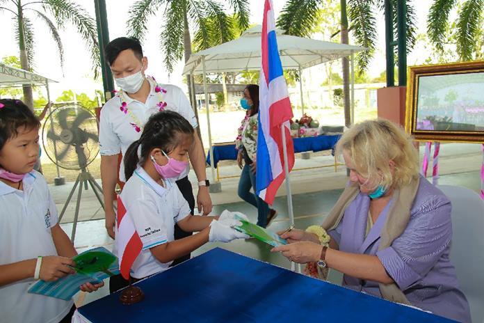 Dr. Eva Hager, Austrian Ambassador to Thailand, hands out signed copies of the book “The Grandma in the Apple Tree”.