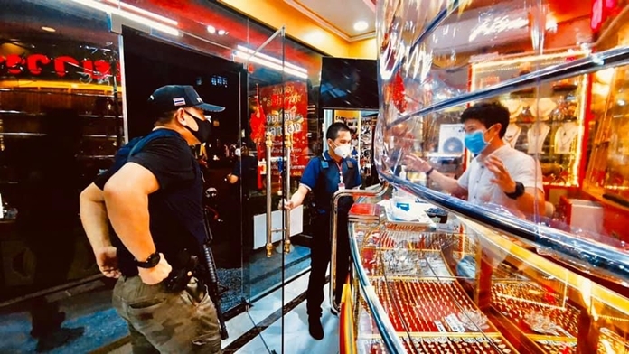 Pattaya police inspect a gold shop.