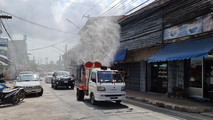 Volunteers sprayed disinfectant in the Sattahip Market Community before splitting up to cover the five subdistricts.