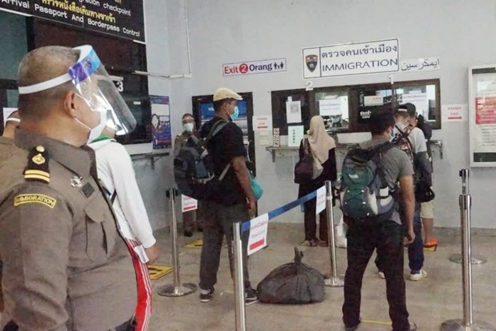 On Saturday at Wang Prachan Thailand-Malaysia border crossing in Satun, Thai nationals line up to cross the border.