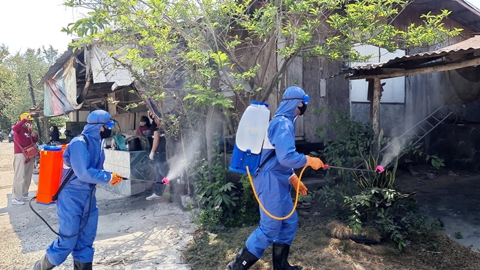 The Covid Killers on the march spraying disinfectant in the Plutaluang community.