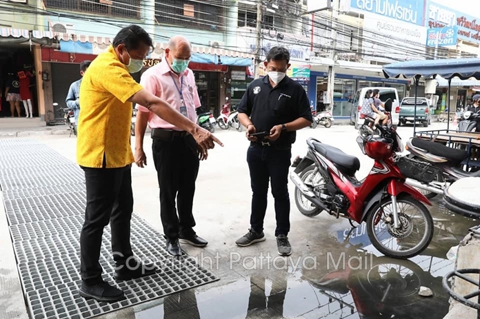 Deputy Mayor Banlue Kullavanijaya is shown where sewage follows out of unconnected pipes.