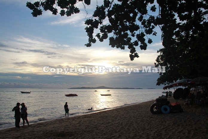 As the sun sets over Pattaya Bay, lovers stroll along the beach cherishing that romantic moment.