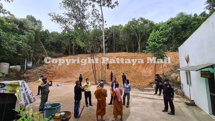 Monks talk to Banglamung district officials about the excavation work around their abbey.