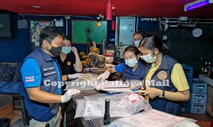 Officials from Special Operation Team inspect documents of the establishment accused human trafficking, pimping of underage minors.